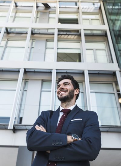low-angle-smiley-lawyer-with-crossed-arms